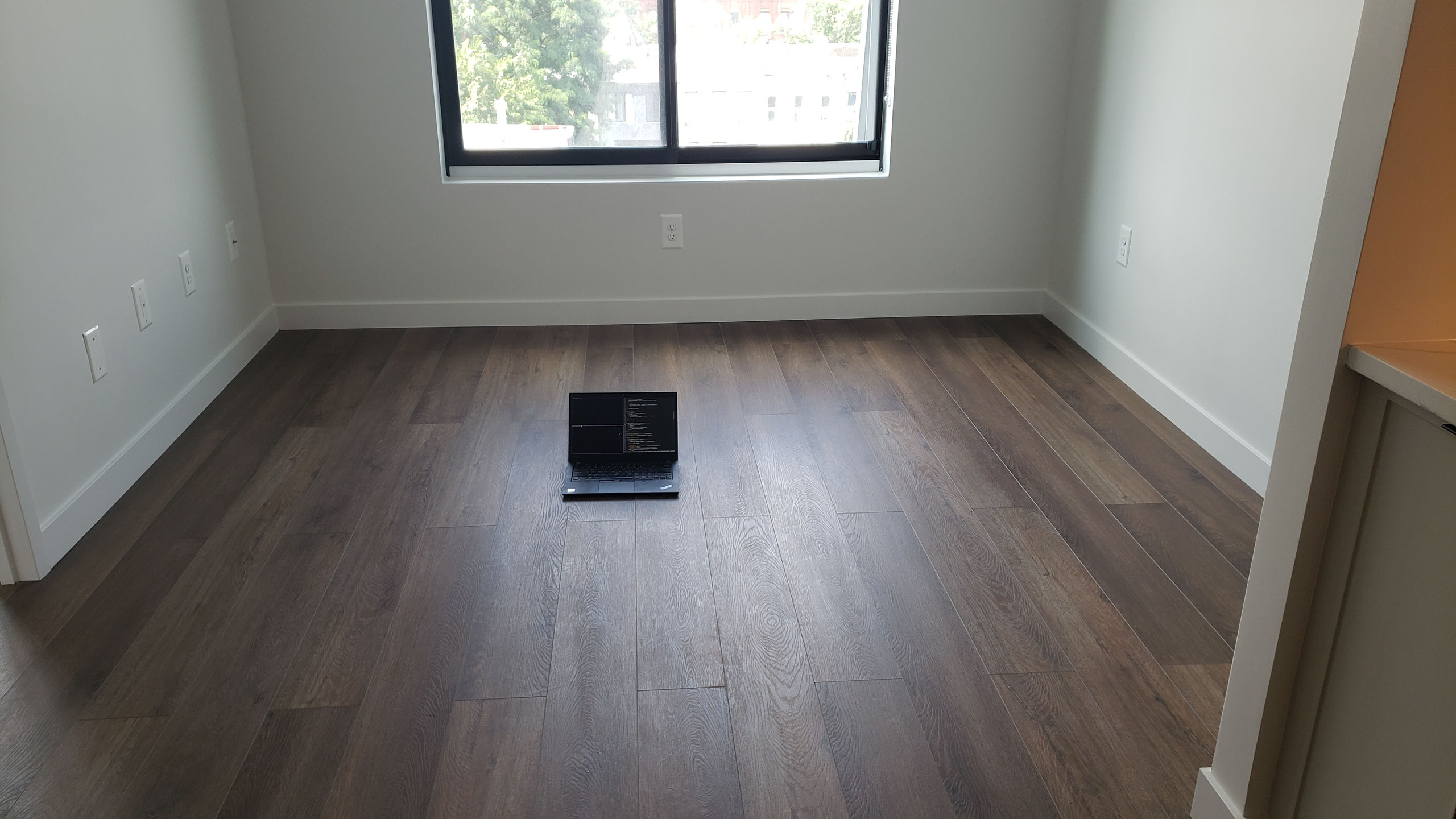 a thinkpad sitting in a very empty room